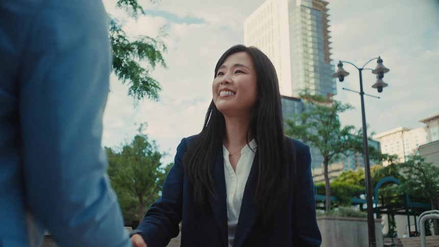 The man and woman greet each other and shake hands