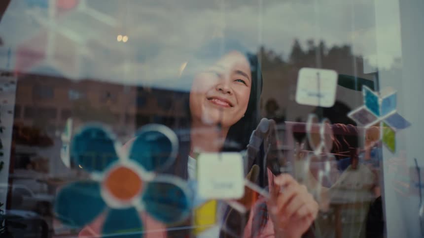 A woman arranging items for sale in a store window