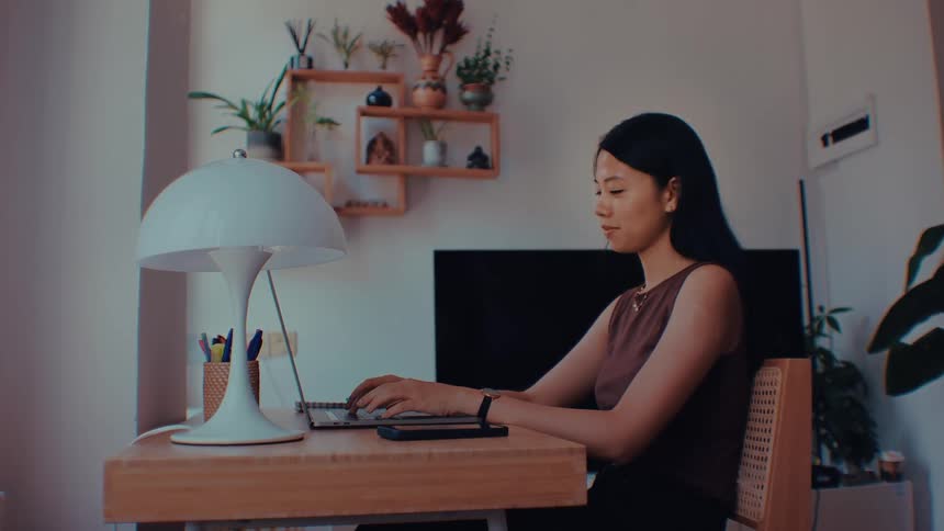 A woman typing on a laptop