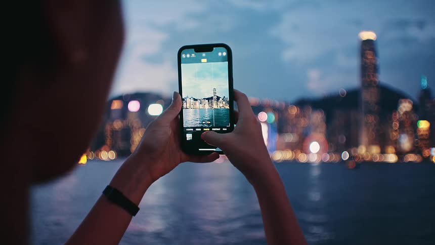A person using a phone to take a photo of a city