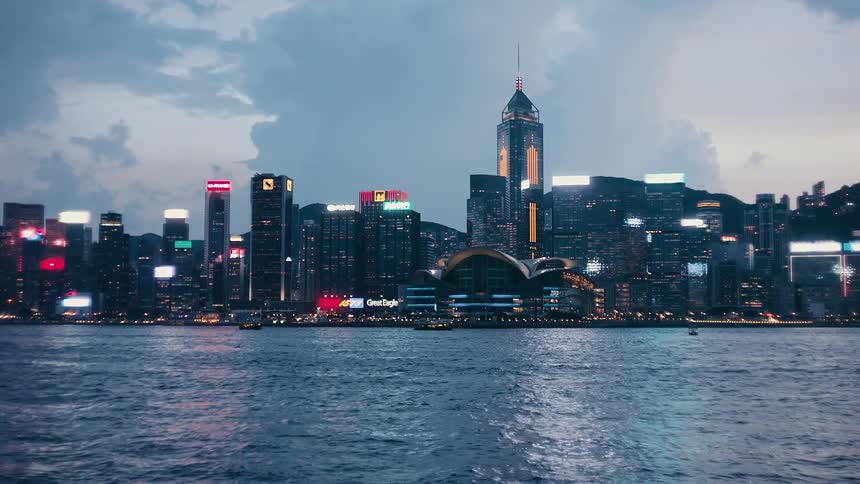 A view of a city at dusk with tall buildings