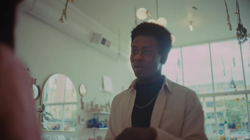 The customer is speaking with an employee in the shop