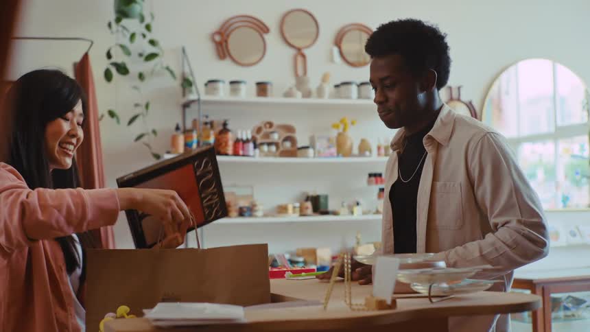A man pays for an item at a store with a credit card