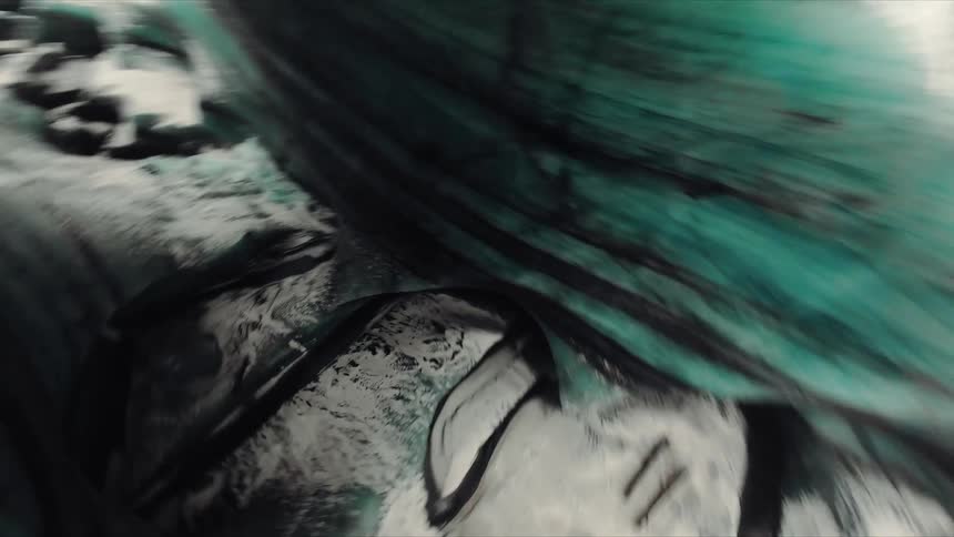 Plunging from the frozen surface an fpv drone navigates a twisting path deep inside a glacial canyon surrounded by walls of vivid blue ice and dark streaks of volcanic ash