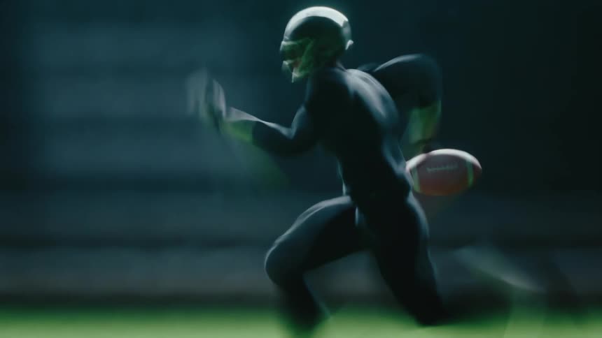 Captured with intense motion blur an american football player in a helmet and dark uniform sprints across the field clutching the ball tightly while moving at high speed