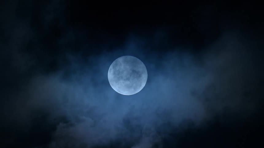 The clouds flow over the full moon at night
