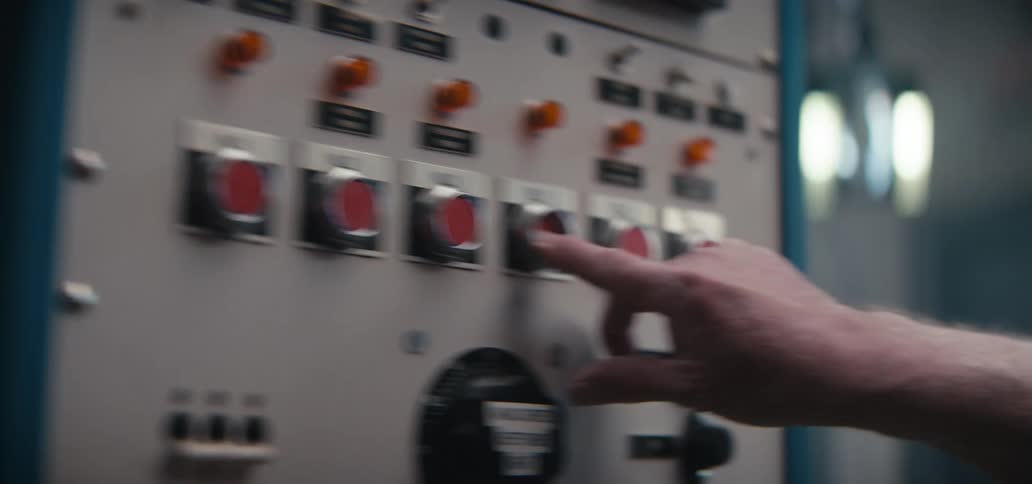 The video shows a closeup panning shot of an industrial control panel featuring various buttons switches and labels it focuses on vintagestyle hardware including prominent red buttons and a dial marked with technical instructions