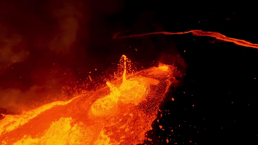 Volcano eruption with lava flows outdoors during night time