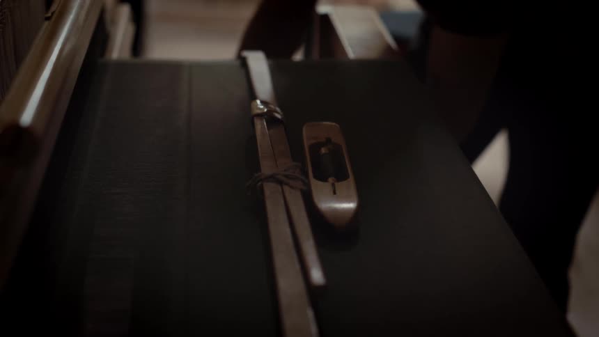 The person puts a strap on the luggage
