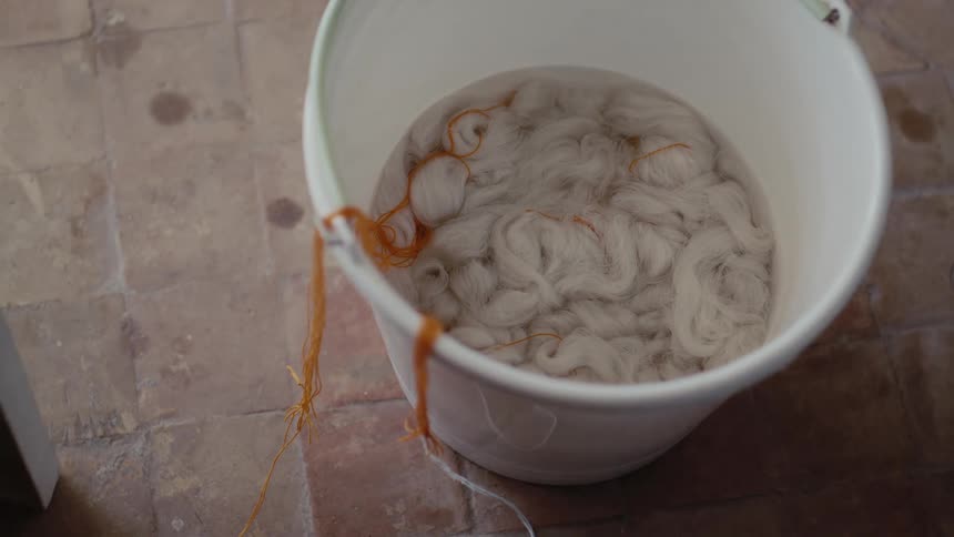 A bucket full of yarn sitting in a factory