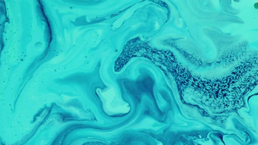 Blue liquid paint flowing across a surface in a zigzag pattern creating shifting curves and sharp turns as it moves