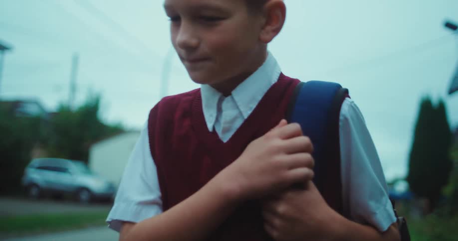 The boy is walking home from school