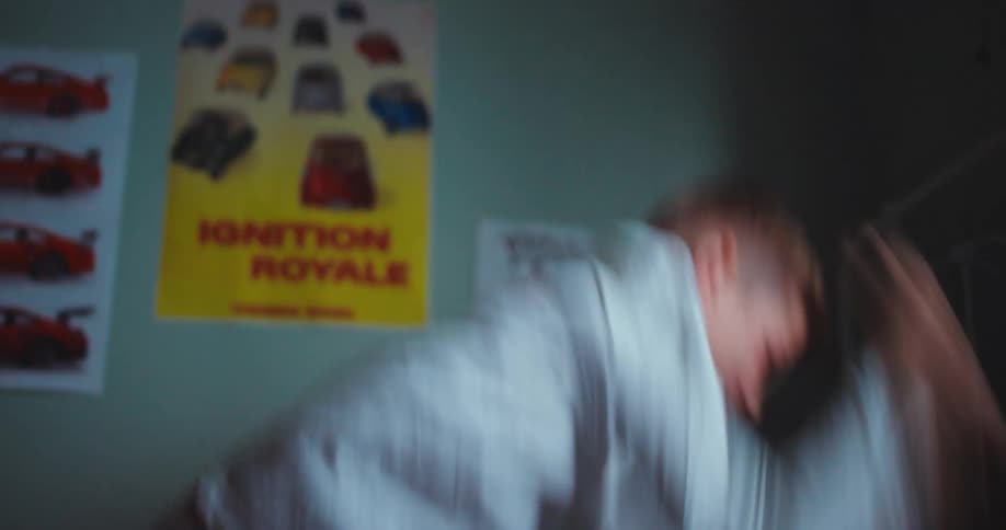 Stressed boy punches pillow on bed