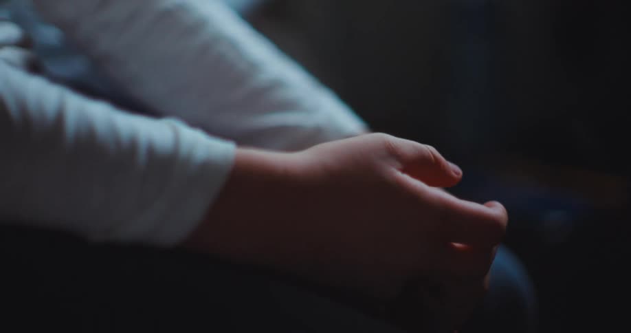 Closeup of a persons clasped hands