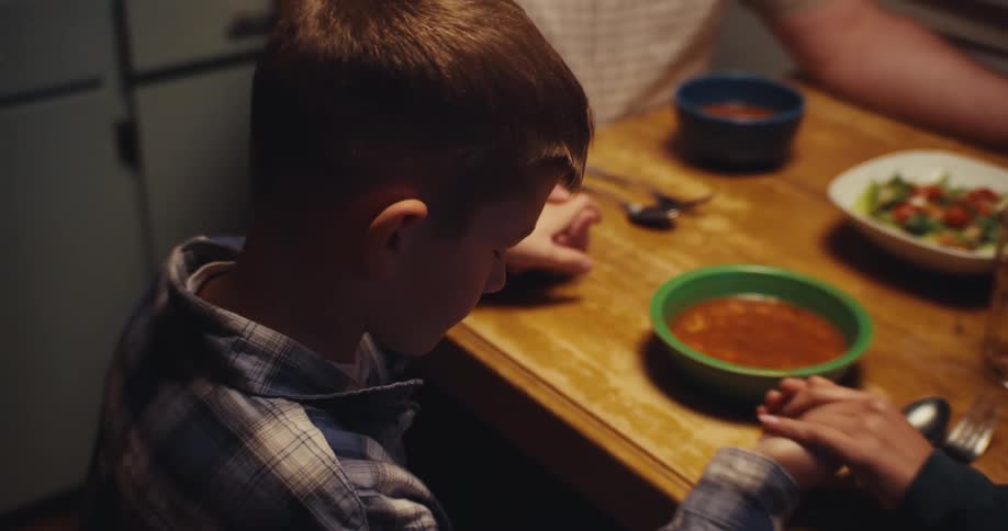 A family saying grace before eating