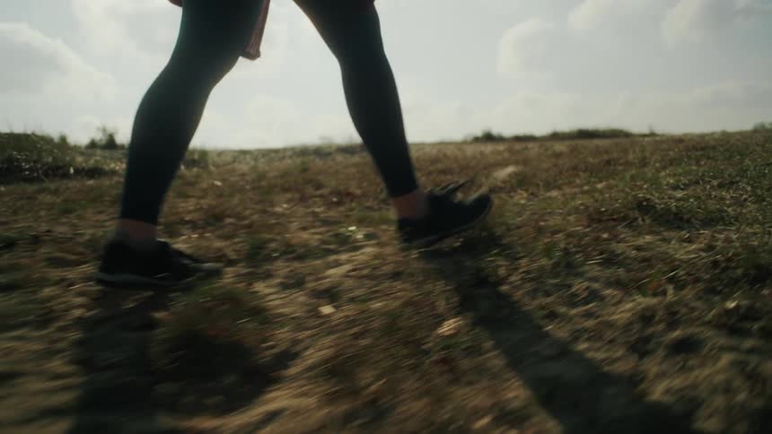 The man walks across the field
