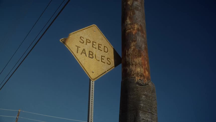 Rusty signpost next to a post