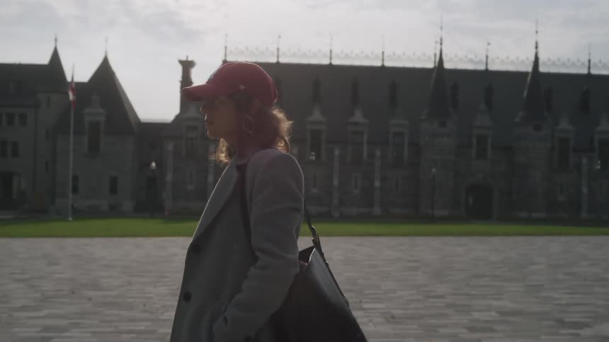 A woman walking around in a city outdoors