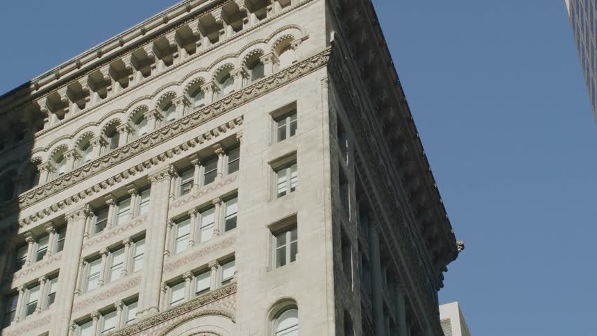 The tall stone building is under the clear sky