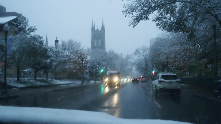 City streets on a snowy day with vehicle traffic