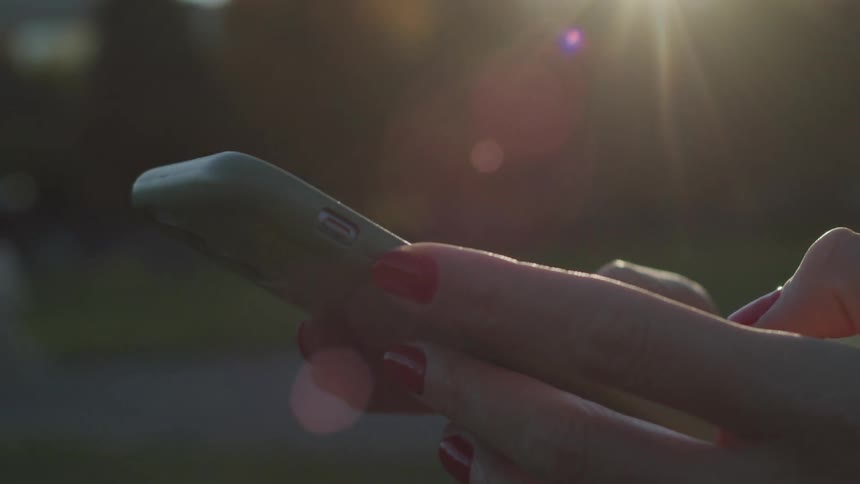 Pair of hands typing on a smartphone