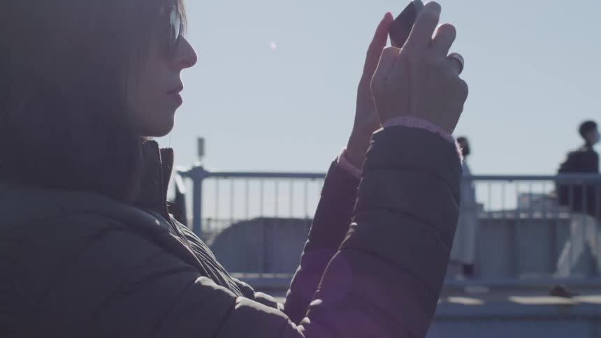 Woman taking photos with a smartphone