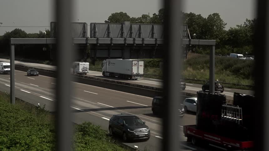 Trucks and cars move in both directions on the freeway