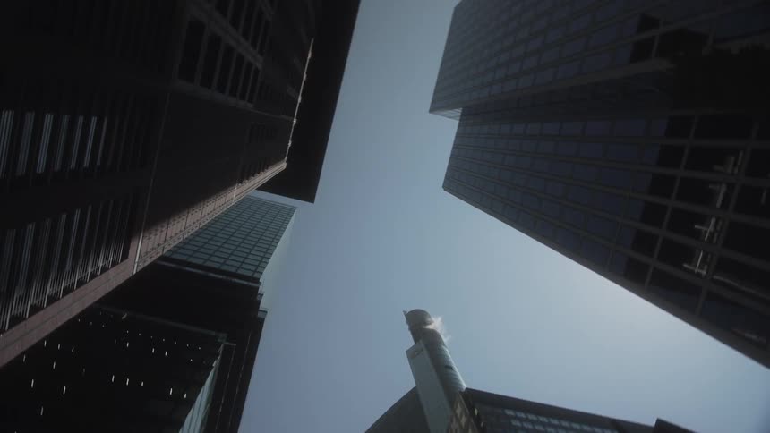 Tall buildings fill the clear sky