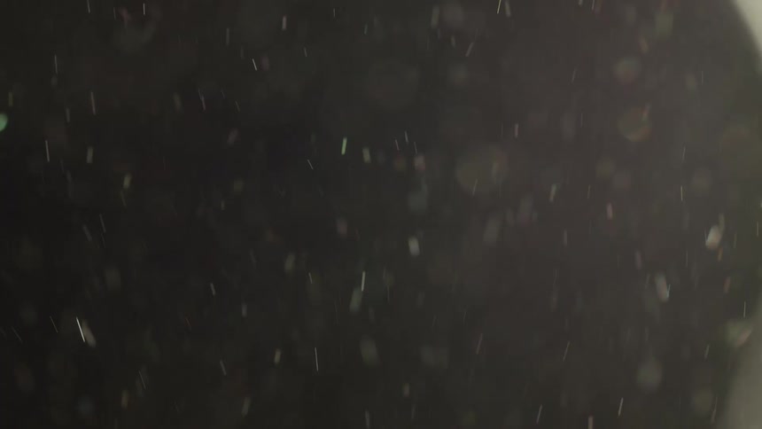 Dust flying through the air against a black background