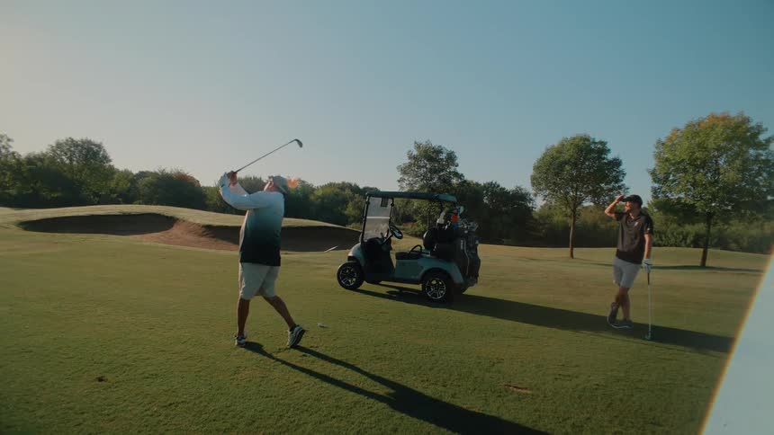 Two men are playing a game of golf