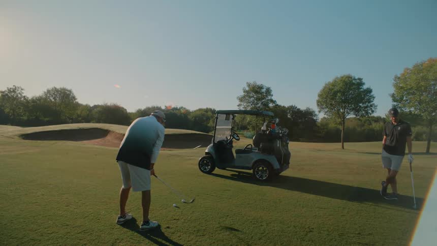Two men getting ready to tee off on a golf course