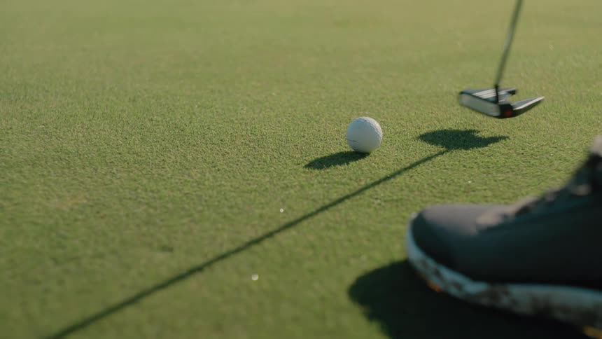 A man putting with a golf club