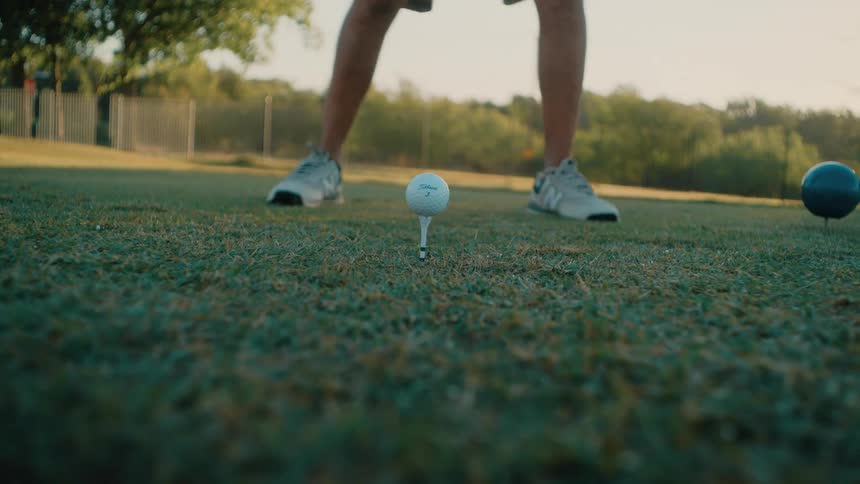 The golf player drives the ball