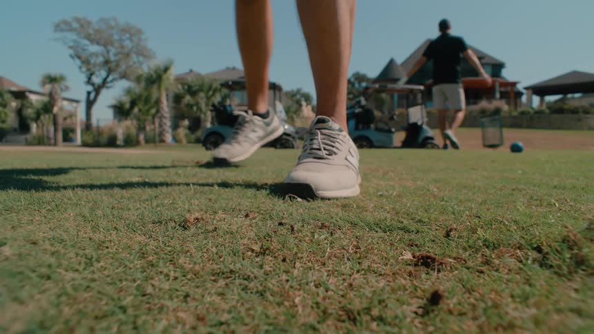 A view of someone grabbing tees while golfing