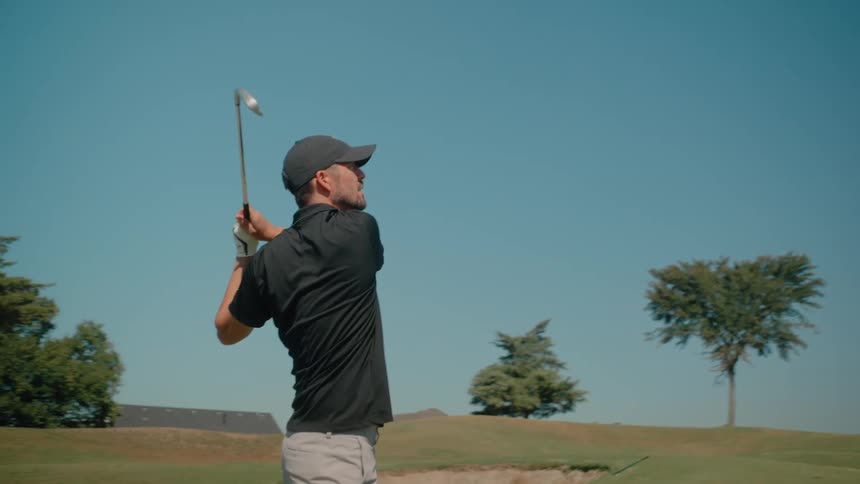 Man hitting a golf ball with a powerful swing