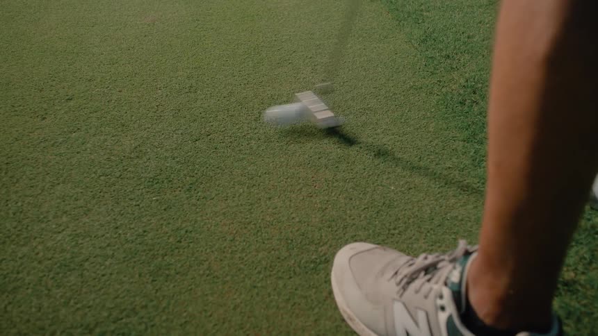 A person putting a golf ball