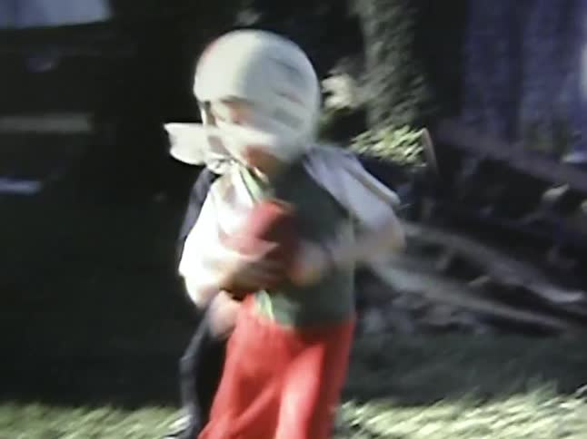 Children wear helmets and play american football on the grass
