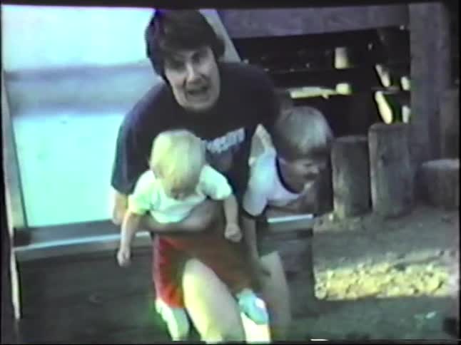 A father and sons going down a slide