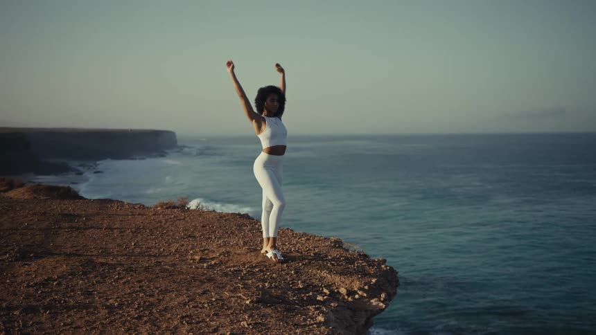 A woman stretching doing yoga outdoors