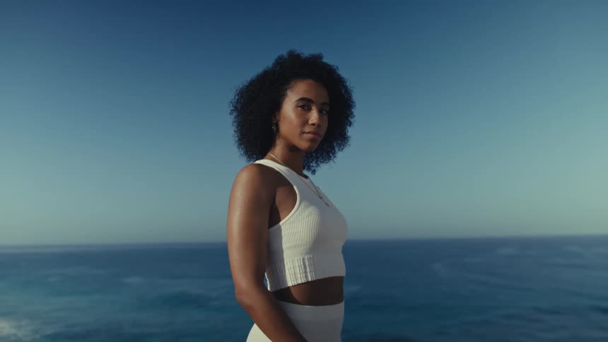 A portrait of a woman outdoors near the ocean