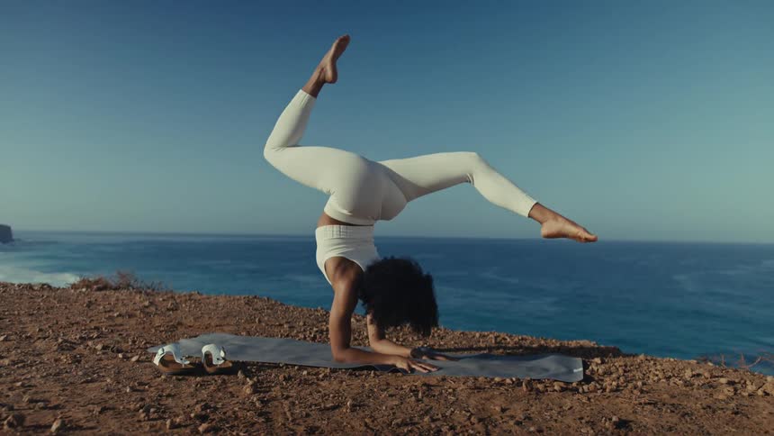 A woman stretching and doing a handstand