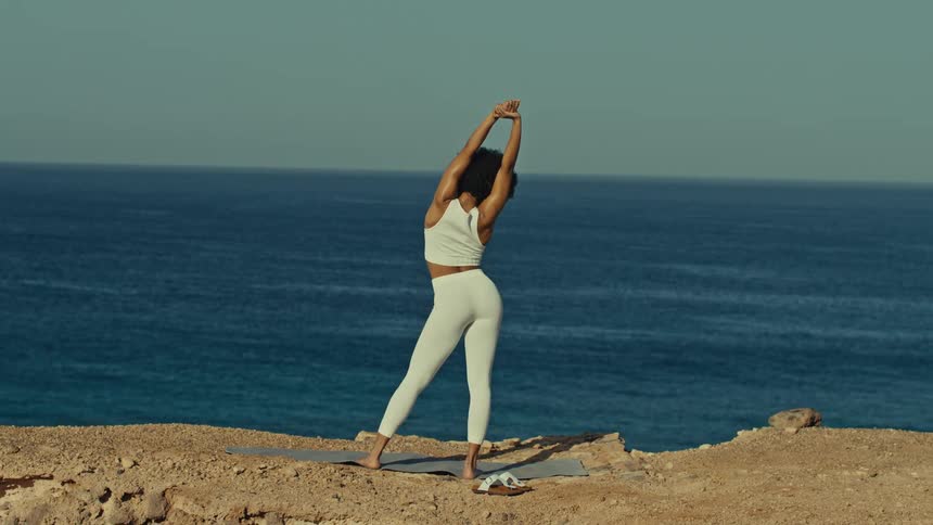 A woman stretching out on the beach