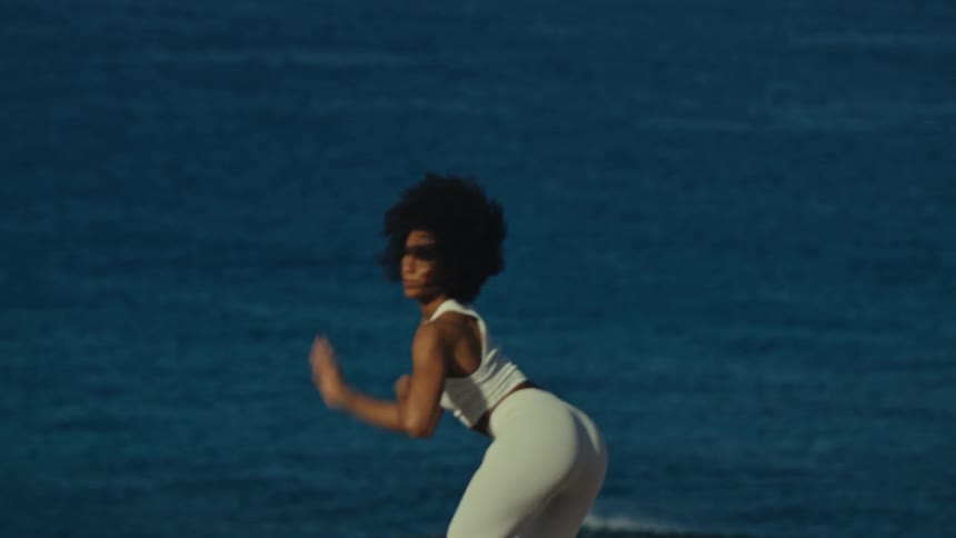 A woman dancing outdoors on a sunny day