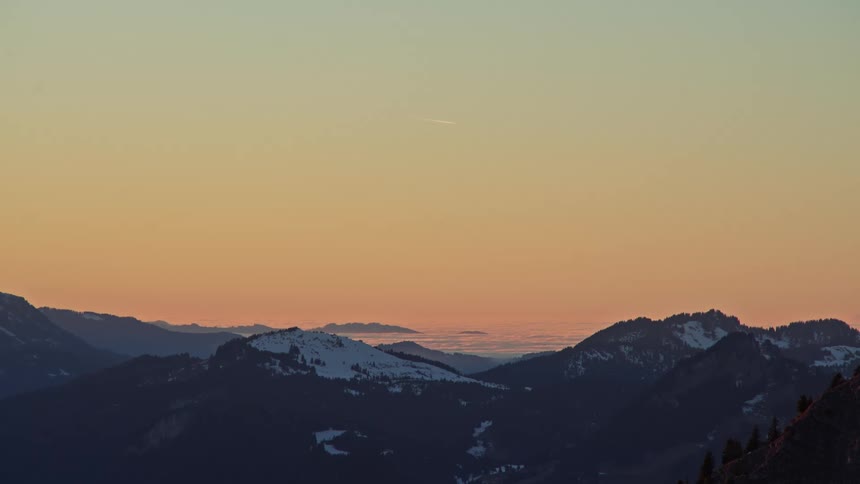 The sun is rising on the mountain range