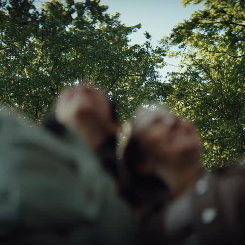 Two women are smiling under the trees