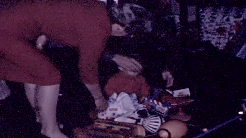 A mother giving her kid christmas presents
