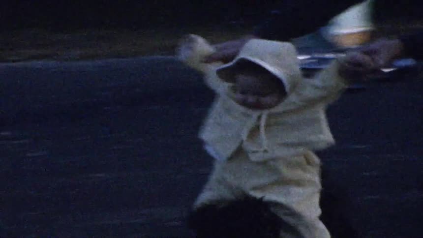 The man helps the baby ride on the running dog