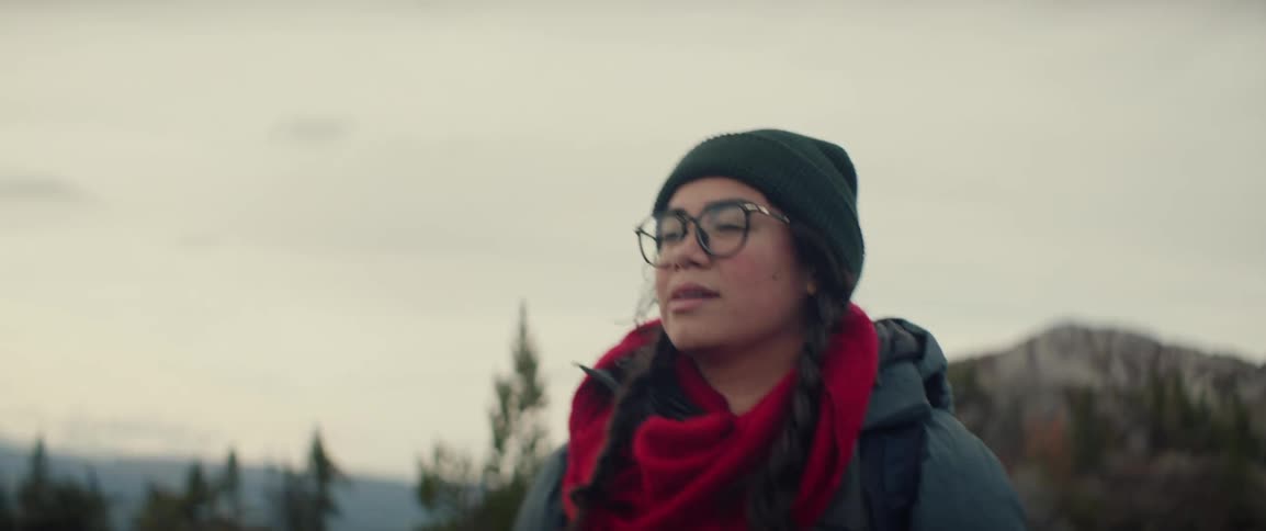 A woman outdoors hiking on a sunny day