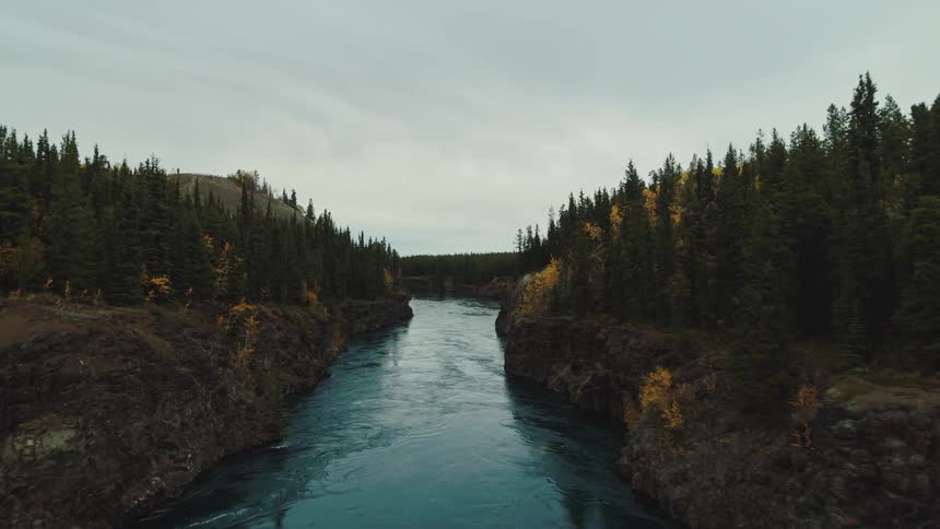 An aerial view of a river passing through a narrow channel with cliffs on either side