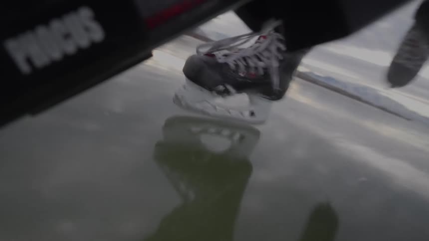 The hockey player races on the ice